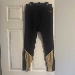 Alala Leggings Sz Med, black front with gold calves and some mesh. 7/8 length.
